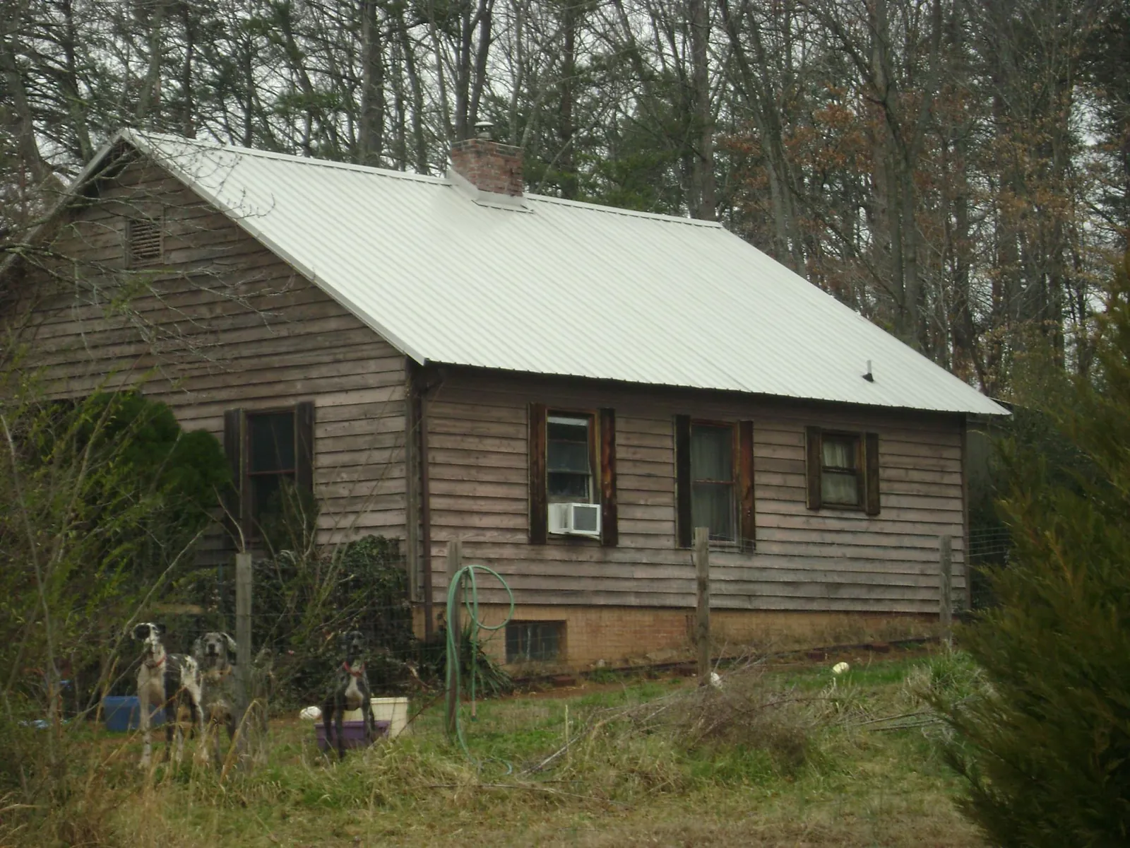 White metal roof on an old wood sided farmhouse, from a Metal Roof Installation job in Westville